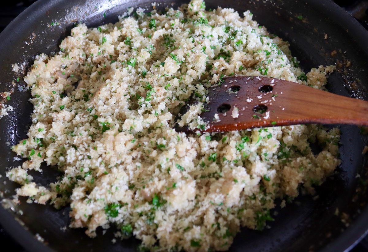 Breadcrumb stuffing for artichokes in a large skillet.